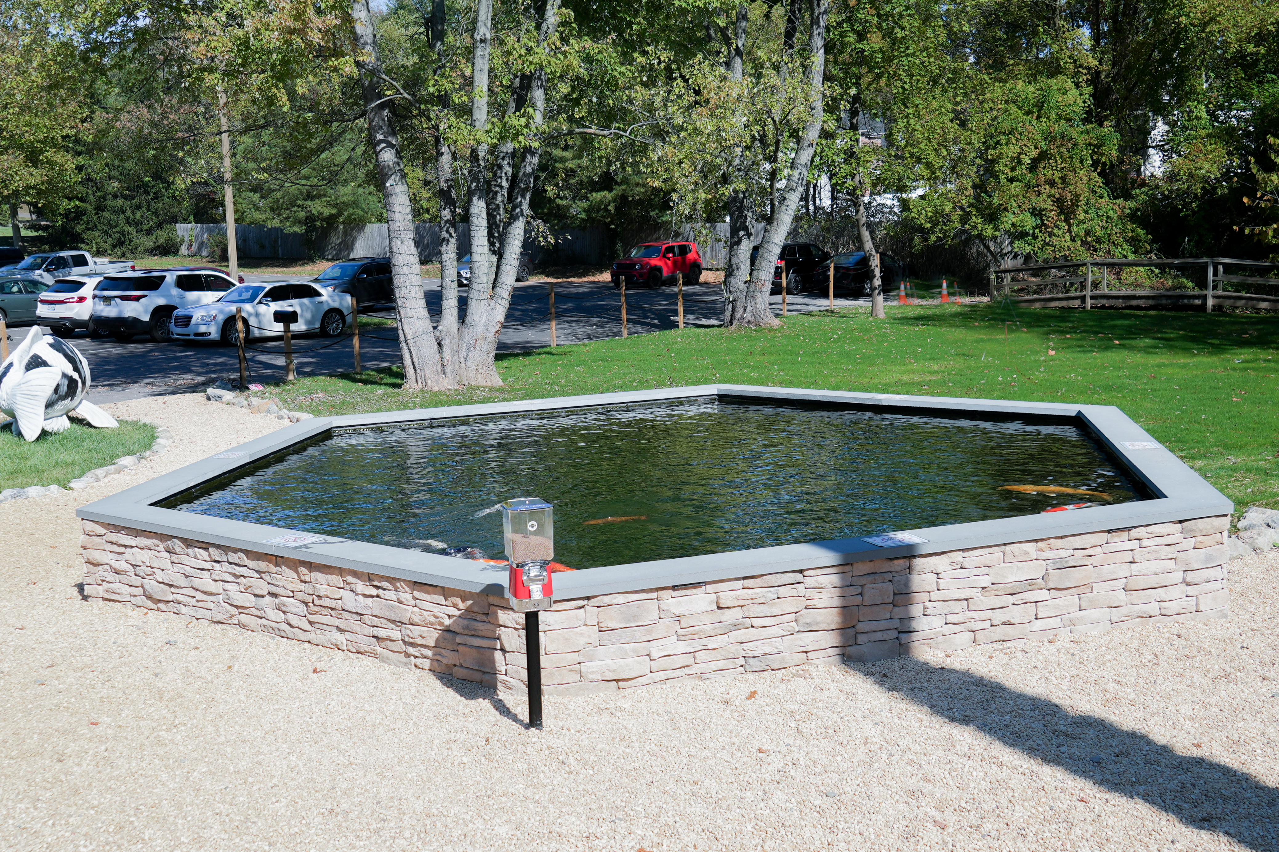 Constructed from durable fiberglass, the pond’s sides were meticulously finished with a colored gel coat for a sleek, polished appearance. A manufactured veneer surrounds the structure, complementing the patio design while offering durability and aesthetic appeal. Constructed from durable fiberglass, the pond’s sides were meticulously finished with a colored gel coat for a sleek, polished appearance. A manufactured veneer surrounds the structure, complementing the patio design while offering durability and aesthetic appeal.